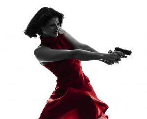 one sexy caucasian woman holding gun in silhouette studio isolated on white background